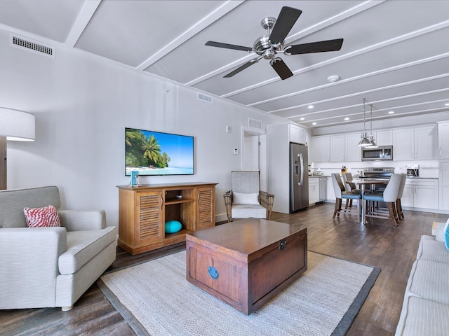 living room featuring dark hardwood / wood-style floors, ceiling fan, and beam ceiling