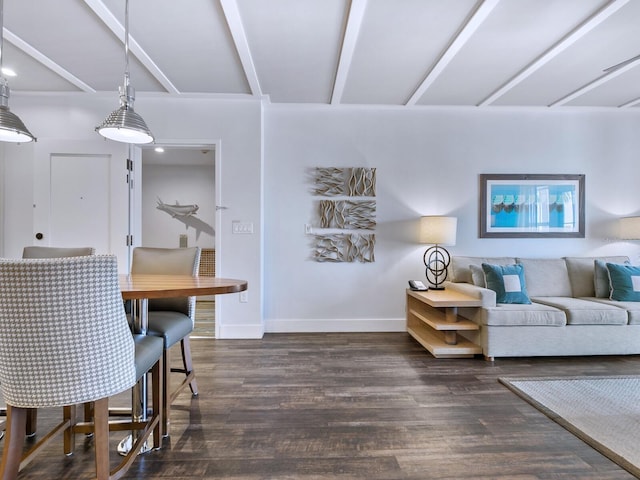 living room with beam ceiling and dark wood-type flooring