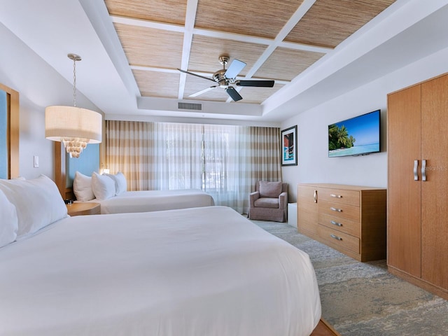 bedroom with a tray ceiling, ceiling fan, and wood ceiling