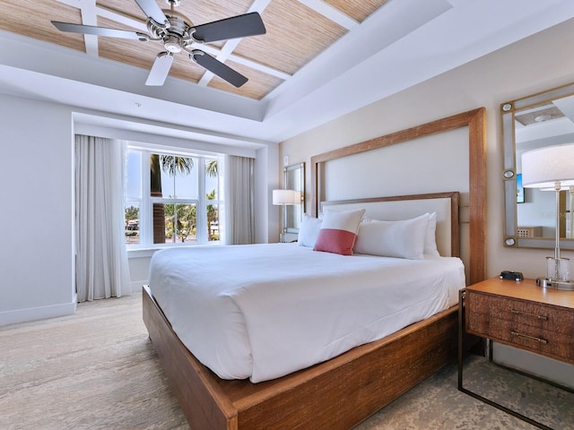 bedroom with a tray ceiling and ceiling fan