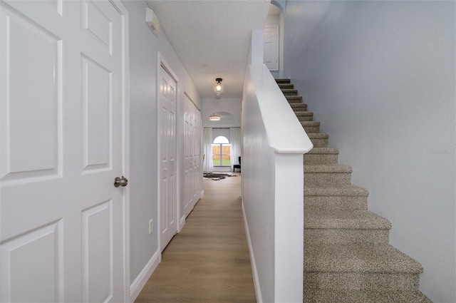 stairs featuring wood-type flooring