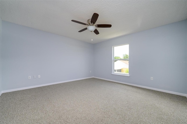 carpeted spare room with a textured ceiling and ceiling fan