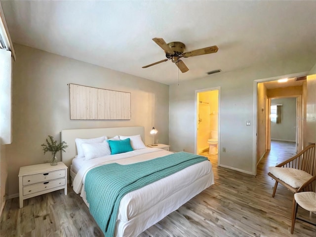 bedroom featuring hardwood / wood-style floors, connected bathroom, and ceiling fan