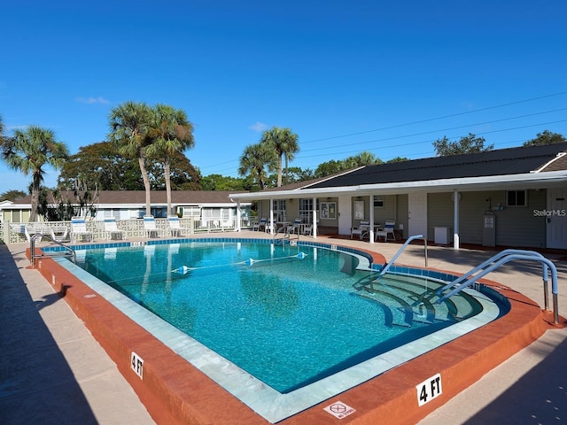 view of swimming pool with a patio