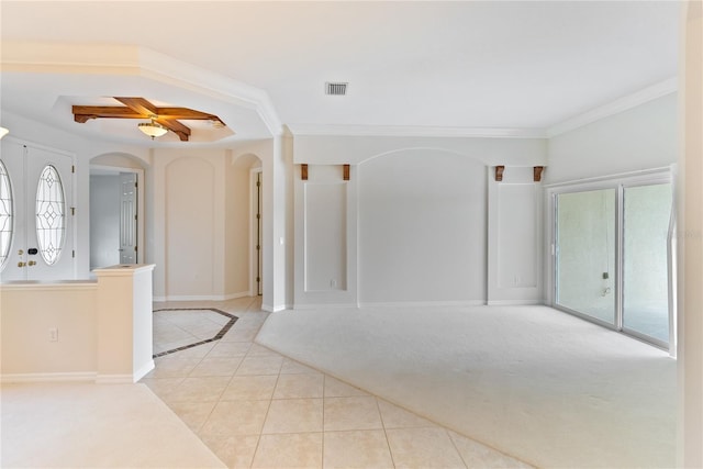 unfurnished room featuring ceiling fan, french doors, light tile patterned floors, and ornamental molding