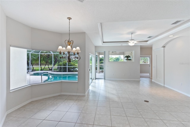 spare room with a textured ceiling, ceiling fan with notable chandelier, a raised ceiling, and light tile patterned flooring