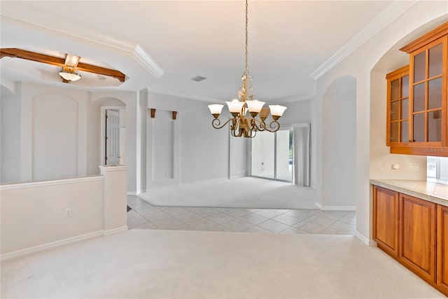 unfurnished dining area featuring light carpet, crown molding, and a chandelier