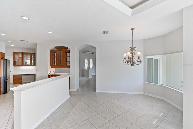 kitchen featuring stainless steel fridge, light tile patterned floors, an inviting chandelier, and pendant lighting