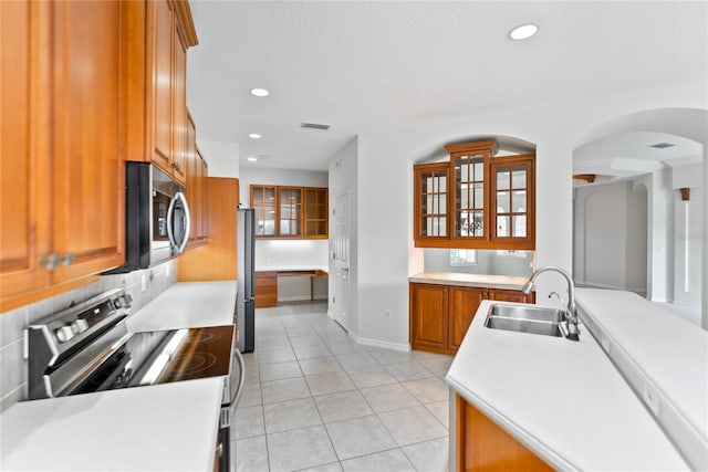 kitchen featuring sink, light tile patterned floors, and stainless steel appliances