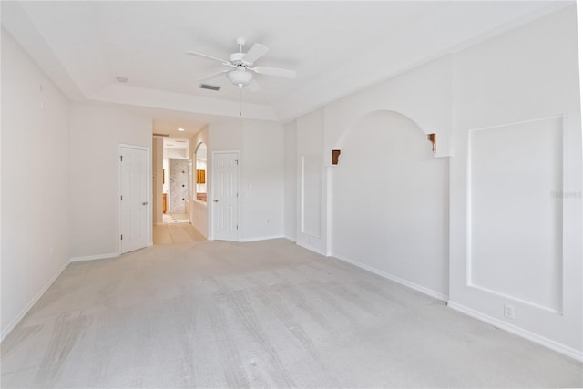 spare room featuring light colored carpet and ceiling fan