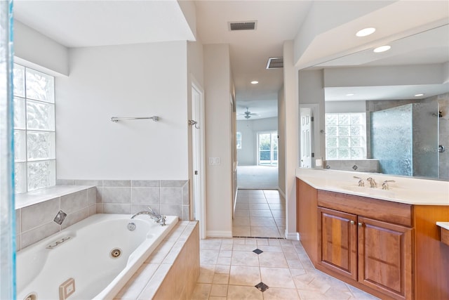 bathroom featuring tile patterned floors, ceiling fan, plus walk in shower, and vanity