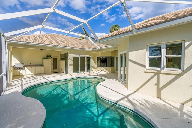 view of swimming pool featuring a lanai, a patio area, and area for grilling