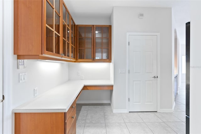 kitchen with light tile patterned flooring and built in desk