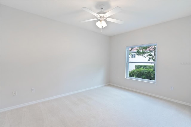 spare room with light carpet and ceiling fan