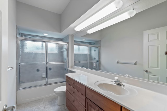 full bathroom featuring tile patterned flooring, vanity, enclosed tub / shower combo, and toilet