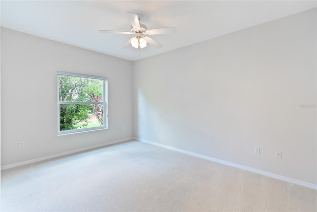 unfurnished room featuring ceiling fan and light carpet