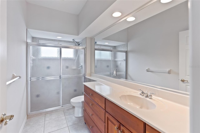 bathroom featuring tile patterned floors, vanity, an enclosed shower, and toilet