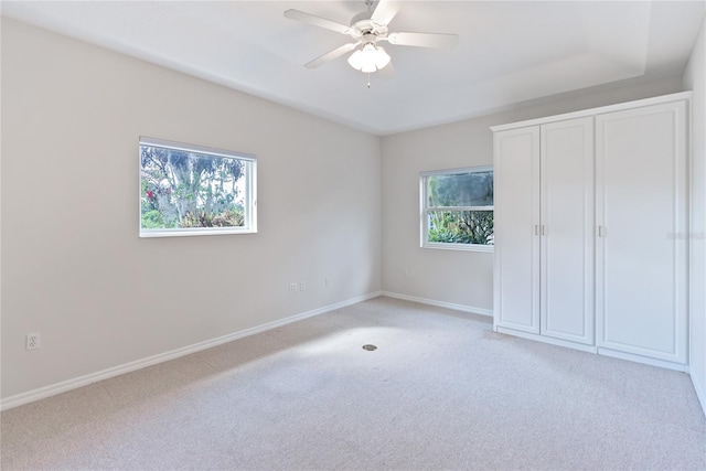 unfurnished bedroom featuring ceiling fan and light colored carpet