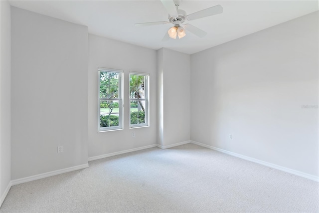 unfurnished room featuring light colored carpet and ceiling fan