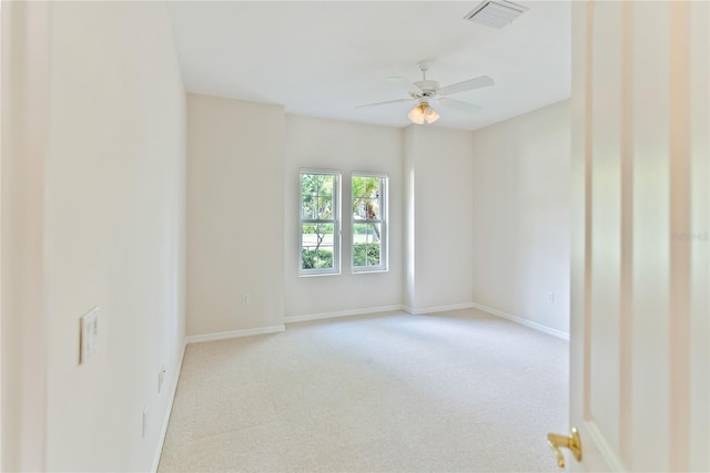 unfurnished room featuring ceiling fan and light carpet