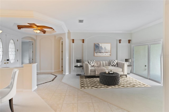 living room featuring ceiling fan, light tile patterned floors, crown molding, and french doors