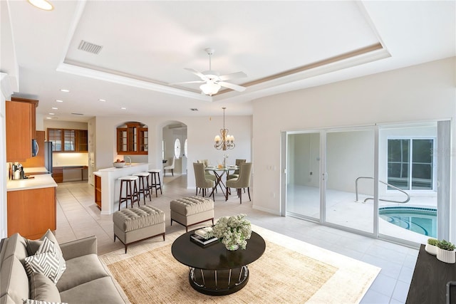 living room featuring light tile patterned floors and a tray ceiling