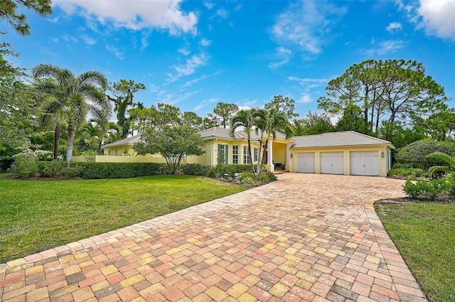 single story home featuring a front yard and a garage