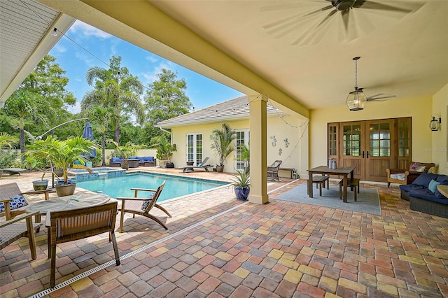 view of swimming pool with french doors, ceiling fan, and a patio area