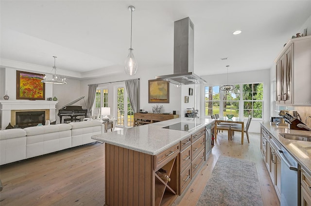 kitchen with black electric stovetop, light wood-type flooring, stainless steel dishwasher, island range hood, and pendant lighting