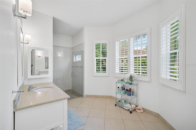 bathroom with tile patterned flooring, vanity, and walk in shower