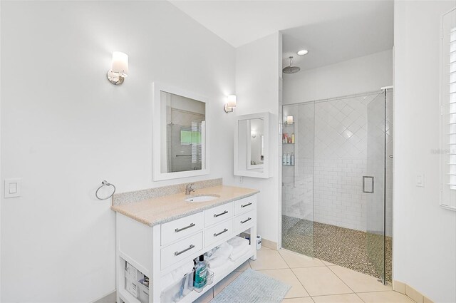 bathroom with tile patterned flooring, vanity, and a shower with shower door