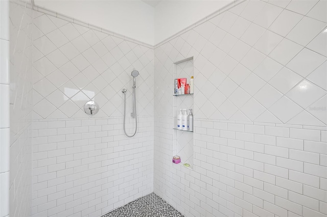 bathroom with a tile shower