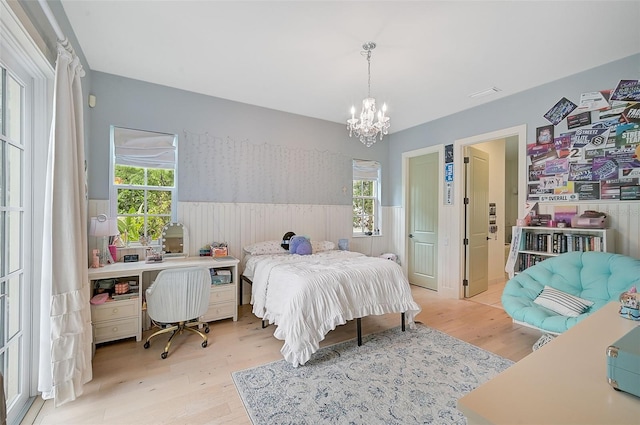 bedroom featuring a notable chandelier and light hardwood / wood-style flooring