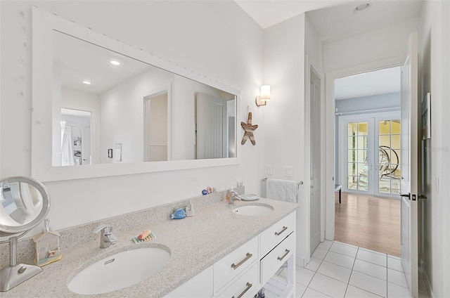 bathroom featuring french doors, vanity, and tile patterned floors