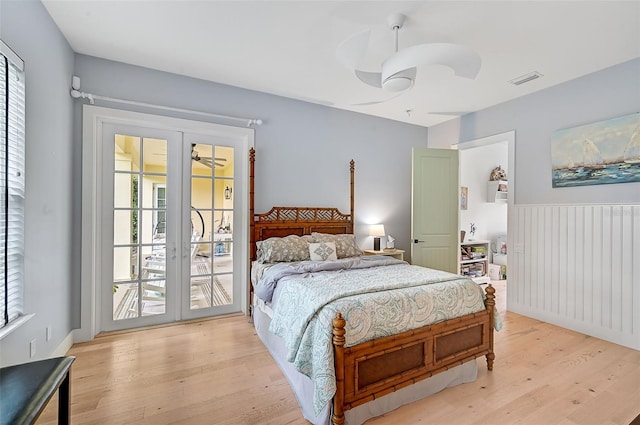 bedroom featuring ceiling fan, light hardwood / wood-style floors, access to outside, and multiple windows