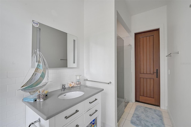 bathroom featuring backsplash, tile patterned flooring, and vanity