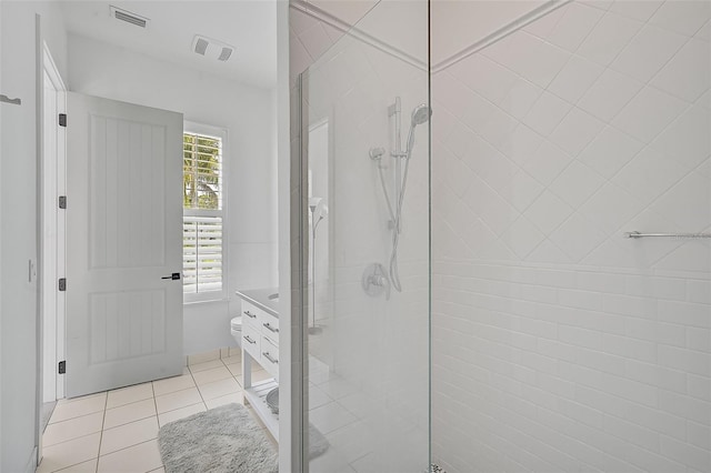 bathroom featuring a wealth of natural light, a shower with door, vanity, and tile patterned flooring