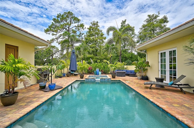 view of pool with an outdoor hangout area, an in ground hot tub, a patio, and french doors