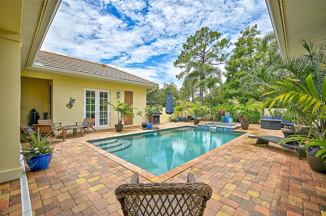 view of pool featuring an in ground hot tub and a patio area