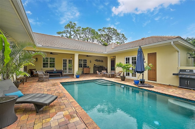 view of pool featuring ceiling fan, french doors, an outdoor hangout area, grilling area, and a patio