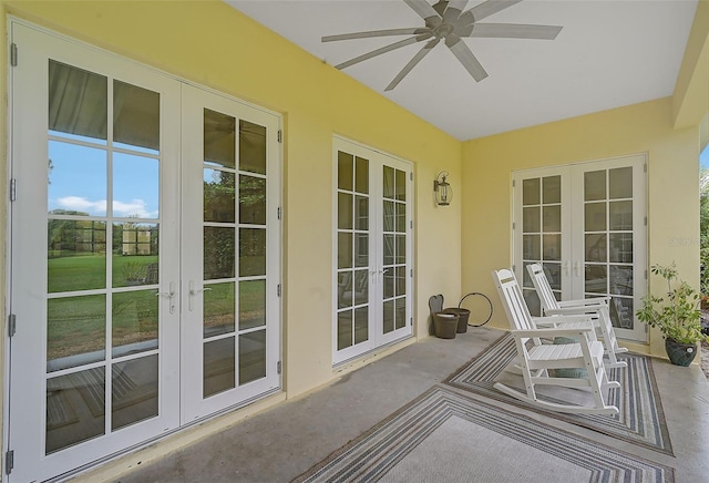 sunroom featuring ceiling fan and french doors