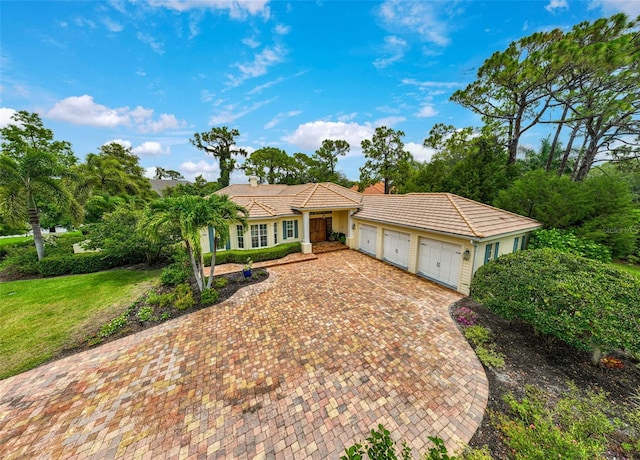 ranch-style house with a front yard and a garage