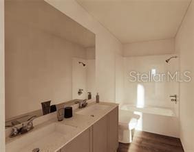 bathroom featuring vanity and bathtub / shower combination