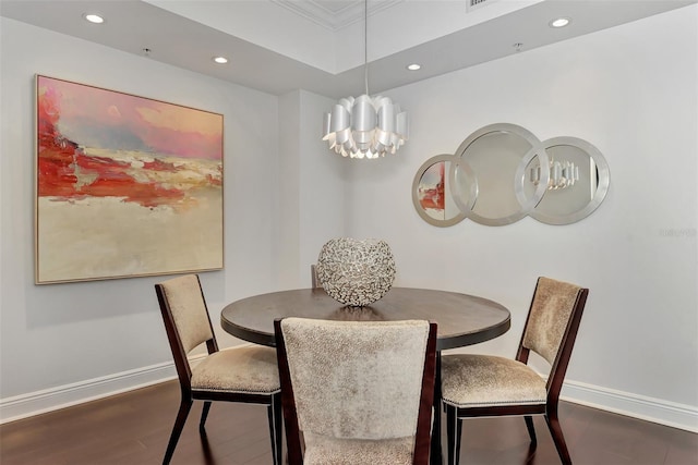 dining area with a notable chandelier, dark hardwood / wood-style flooring, and crown molding