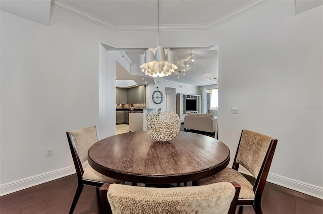 dining room with crown molding, dark hardwood / wood-style floors, and a notable chandelier