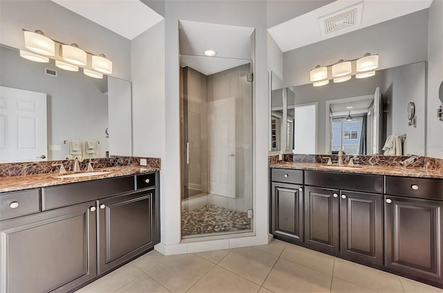 bathroom featuring tile patterned flooring, vanity, and walk in shower