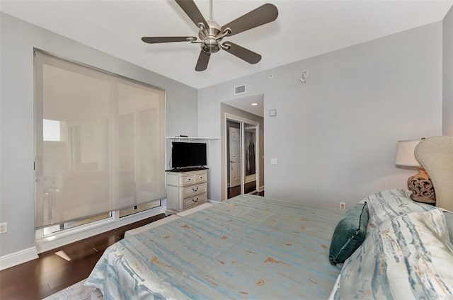 bedroom with hardwood / wood-style floors, a closet, and ceiling fan