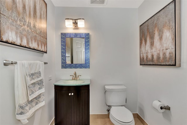 bathroom with tile patterned floors, vanity, and toilet