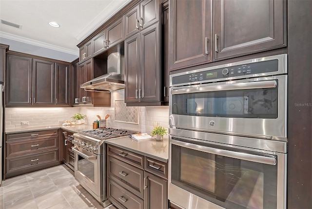 kitchen featuring decorative backsplash, dark brown cabinetry, ornamental molding, and appliances with stainless steel finishes