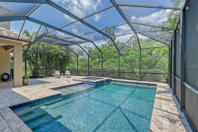 view of swimming pool with an in ground hot tub, a patio, and a lanai